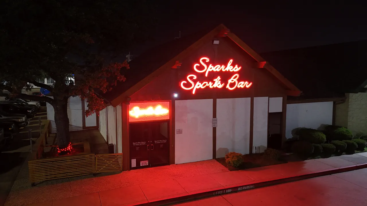 Sparks Sports Bar entrance and red neon sign on Rufe Snow Drive