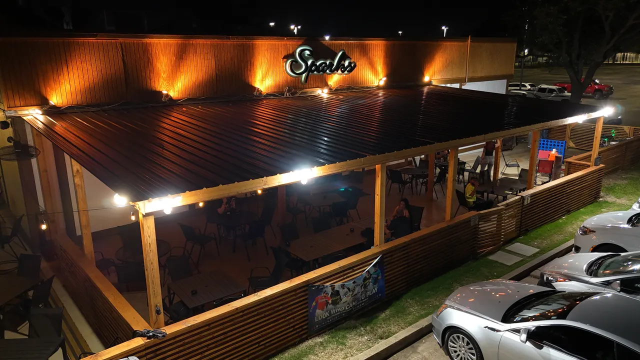 Covered outdoor seating at Sparks Sports Bar at night